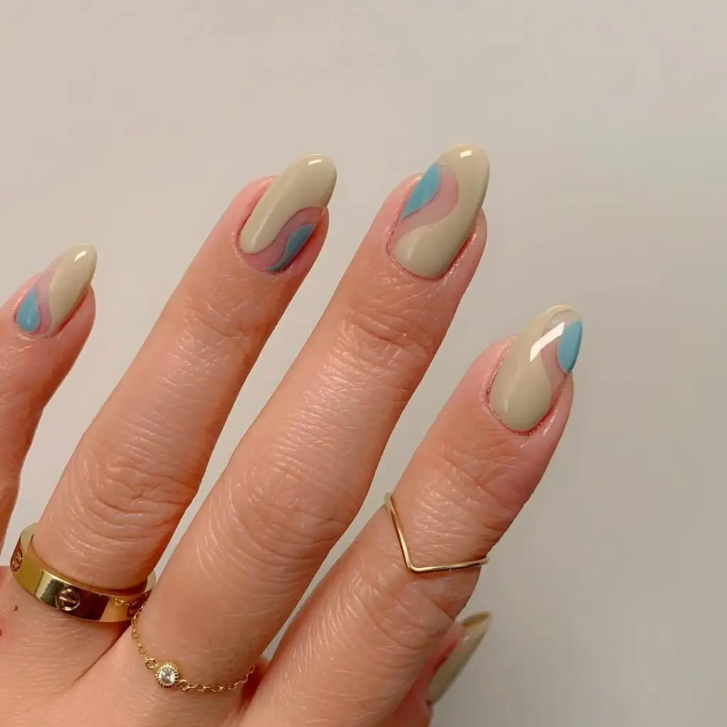 Nude almond nails with abstract blue and pink swirl design