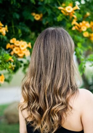 Long brunette hair with balayage highlights and loose waves