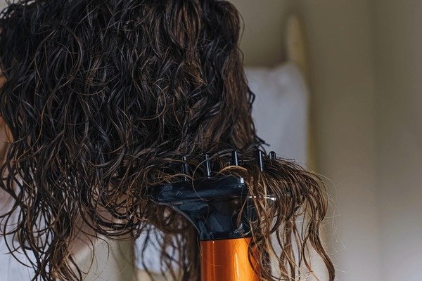 Diffuser blow-drying curly layered hair