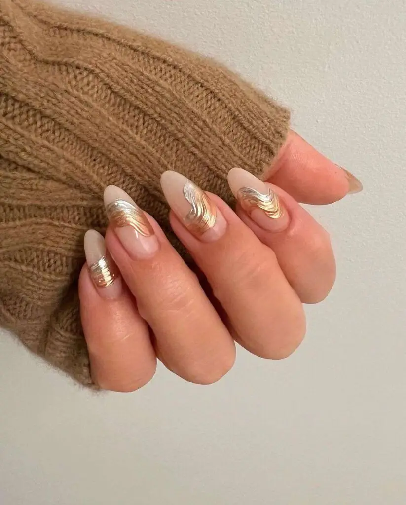 Nude almond nails with gold and silver swirl line art
