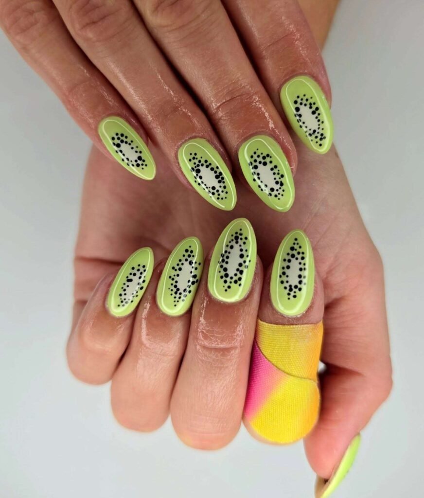 Lime green kiwi-inspired nails with black seed dot details