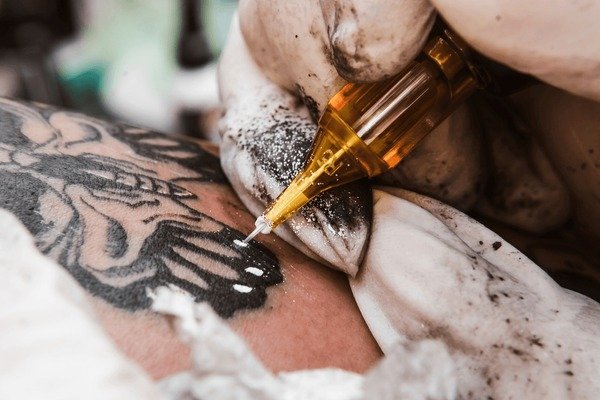 Close-up of fine-line tattoo needle used for micro tattoos