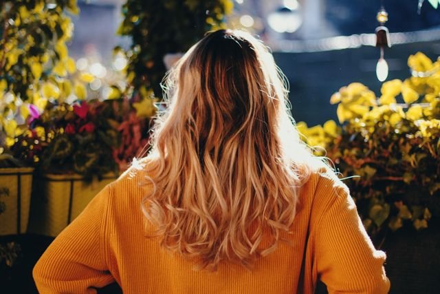 Warm blonde wavy hair color in golden evening light
