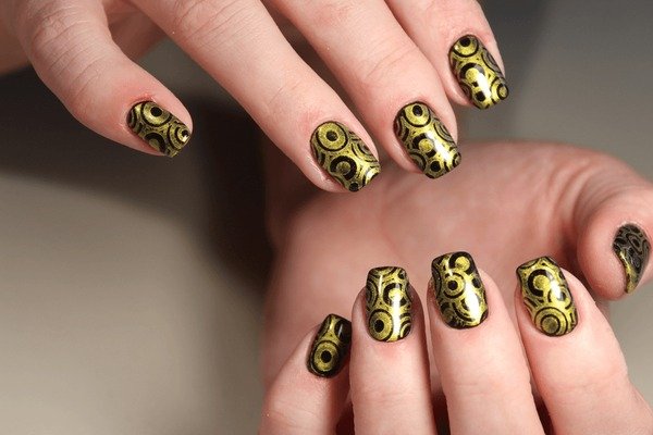Black abstract line nail art with gold dot accents