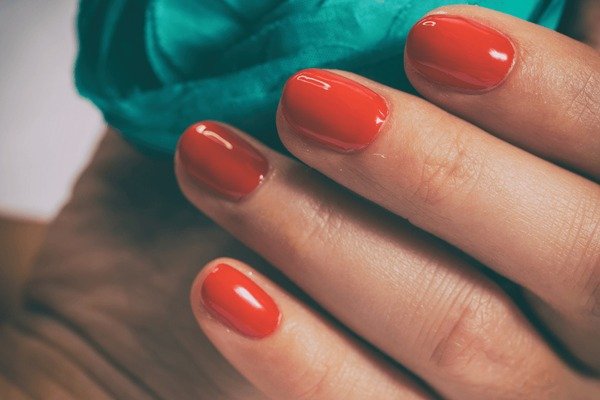 glossy red gel manicure mirror finish close up