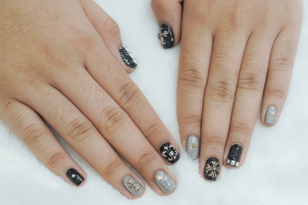 Mismatched nail art with mixed prints on one hand